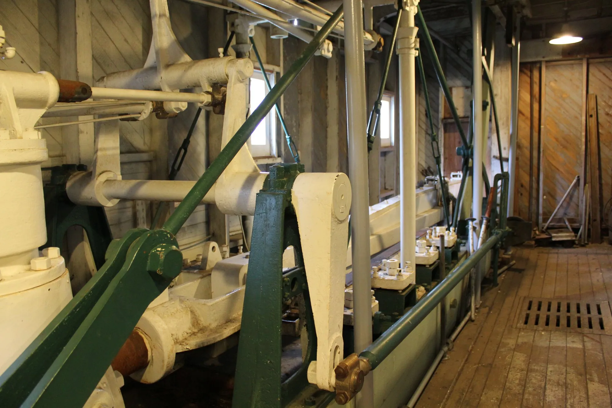 Rocker arm and green diagonal frame members of the engine, looking aft along the engine room