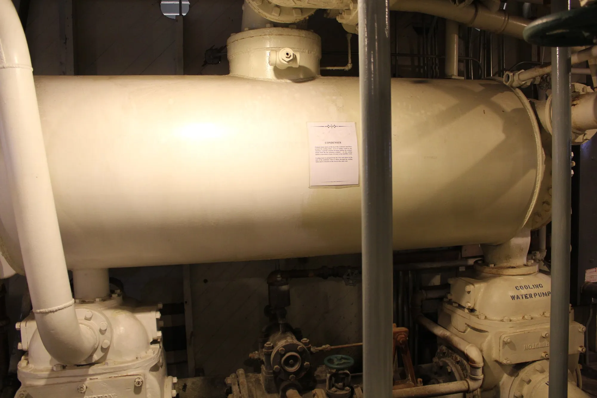 Large horizontal white shell carried above two pumps, one marked Cooling Water Pump