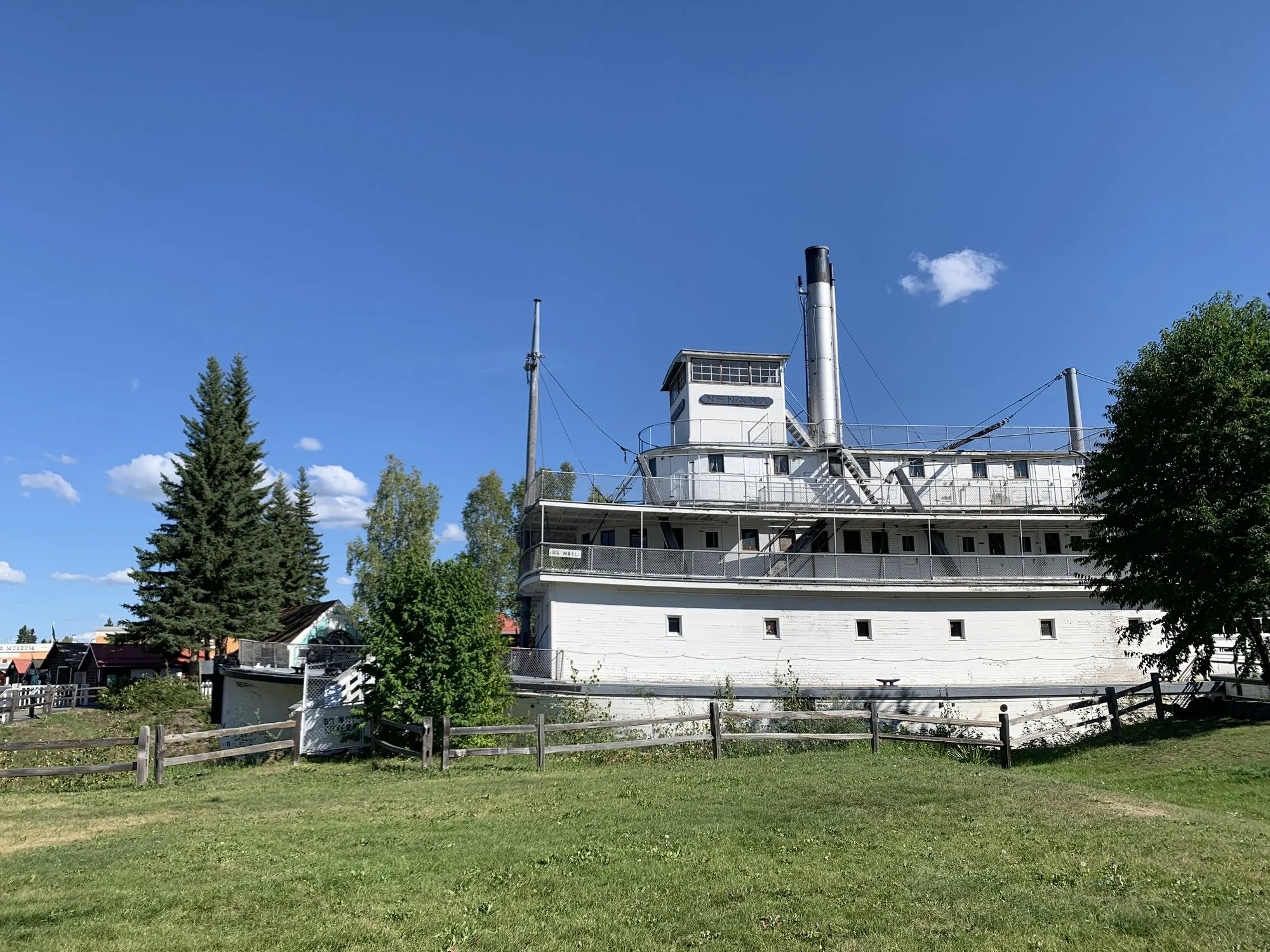 The Nenana seen broadside across a lawn, with trees on either side